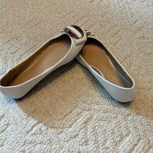 Pretty white flats with gold detail at toe. Size 7.